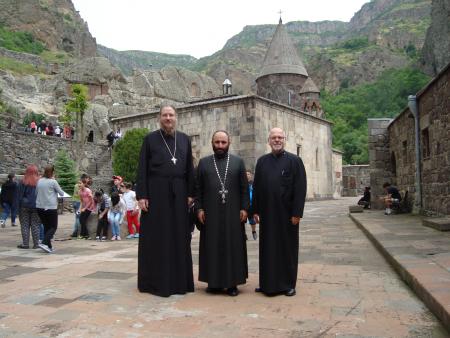 (from left) Fr. John Behr, dean of St. Vladimir’s Seminary, Abbot of the Geghard Monastery, and Fr. Mardios Chevian, dean of St. Nersess Seminary, at the Geghard Monastery in Armenia.